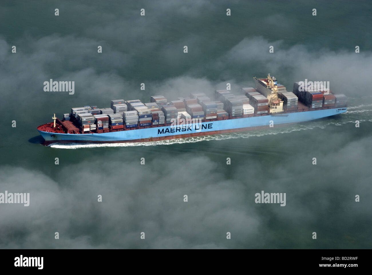 The Maersk Seville emerging from the sea fog. Stock Photo