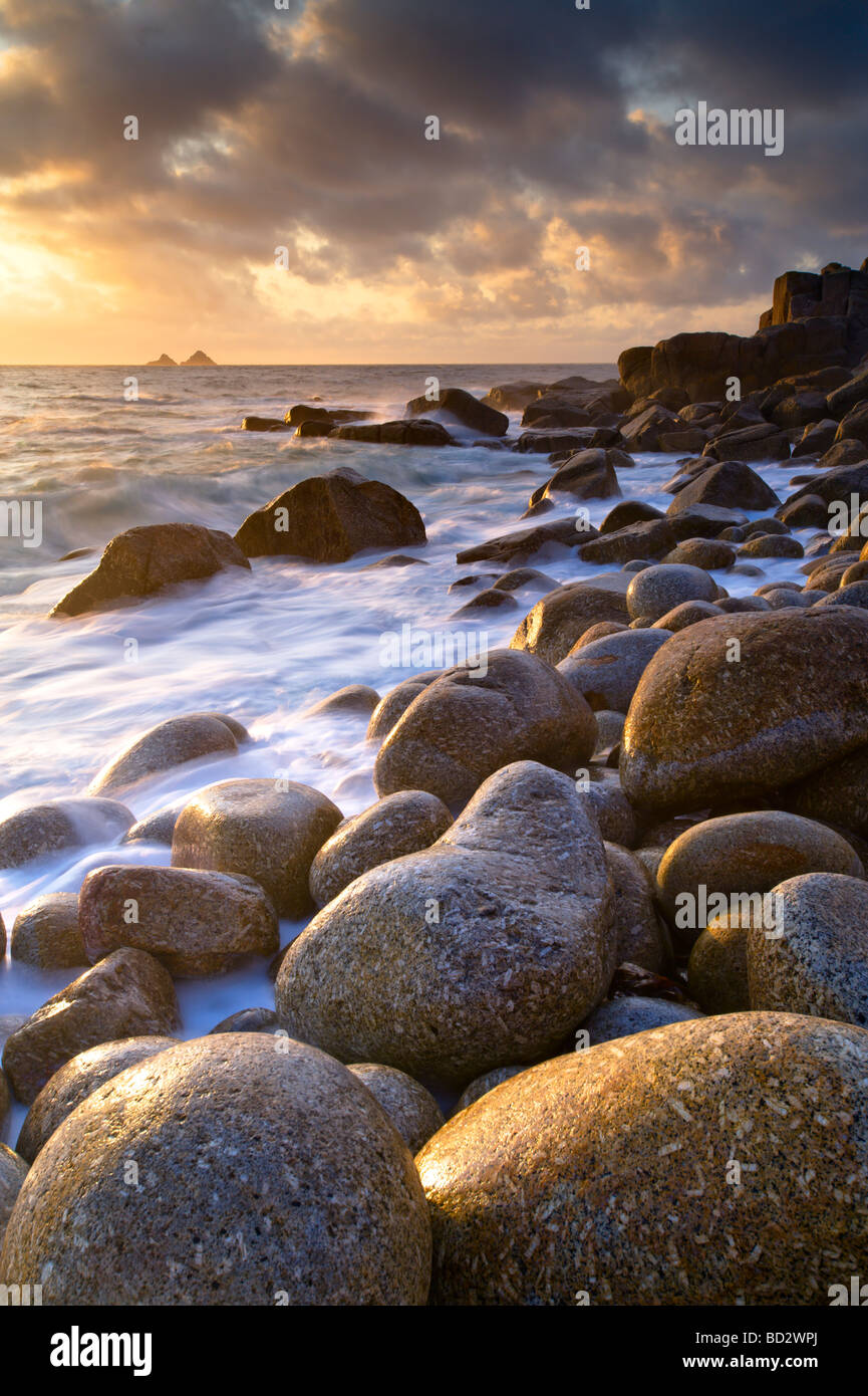 Stunning evening light glistens off the wet boulders near Porth Nanven in South West Cornwall. Stock Photo