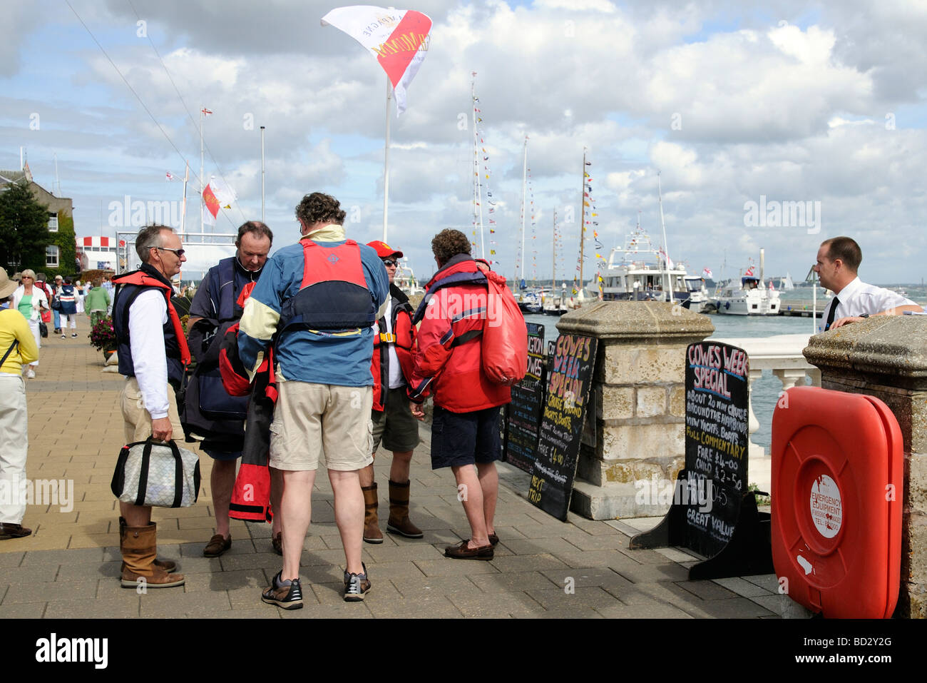 Yachtsmen on the Trinity Landing waterfront at Cowes Isle of Wight