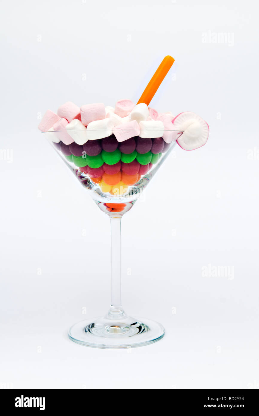 Still life artistic shots of mixture of different sweets in cocktail glass against a white background Stock Photo