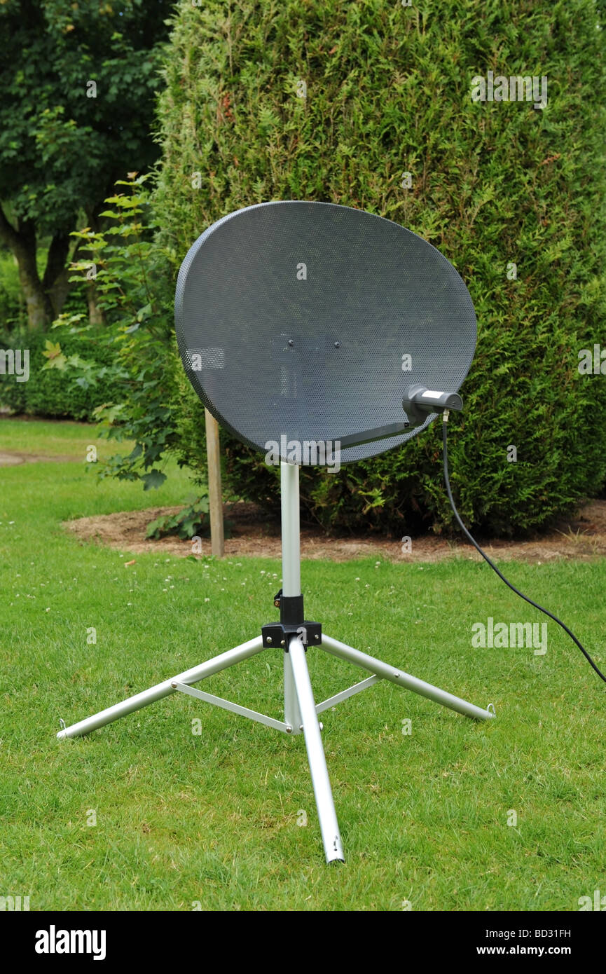 Portable satellite dish equipment on a collapsable tripod mount seen on a  caravan park Stock Photo - Alamy