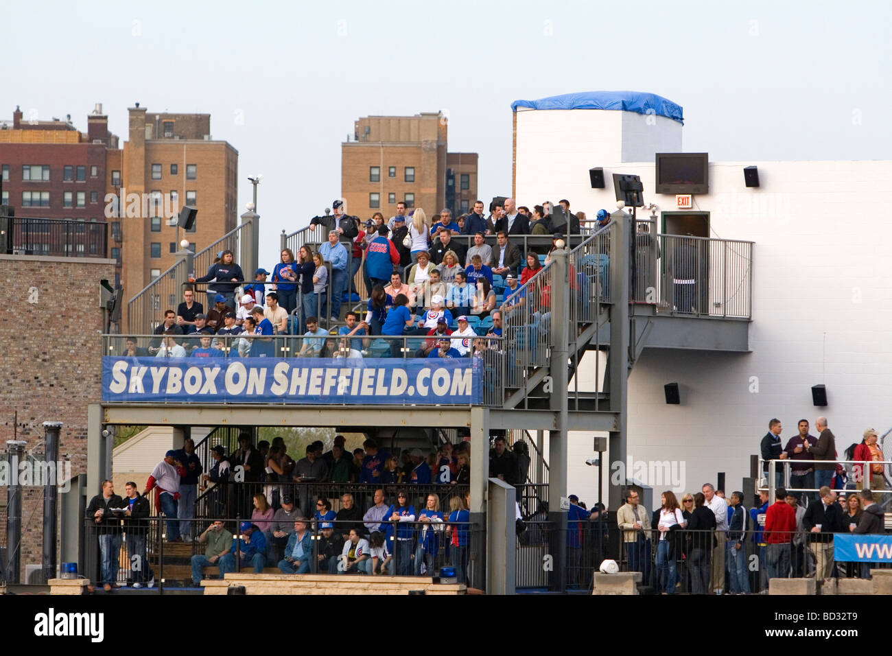 Fans watch a Cubs baseball game from a luxury skybox at Wrigley Field in Chicago Illinois USA  Stock Photo
