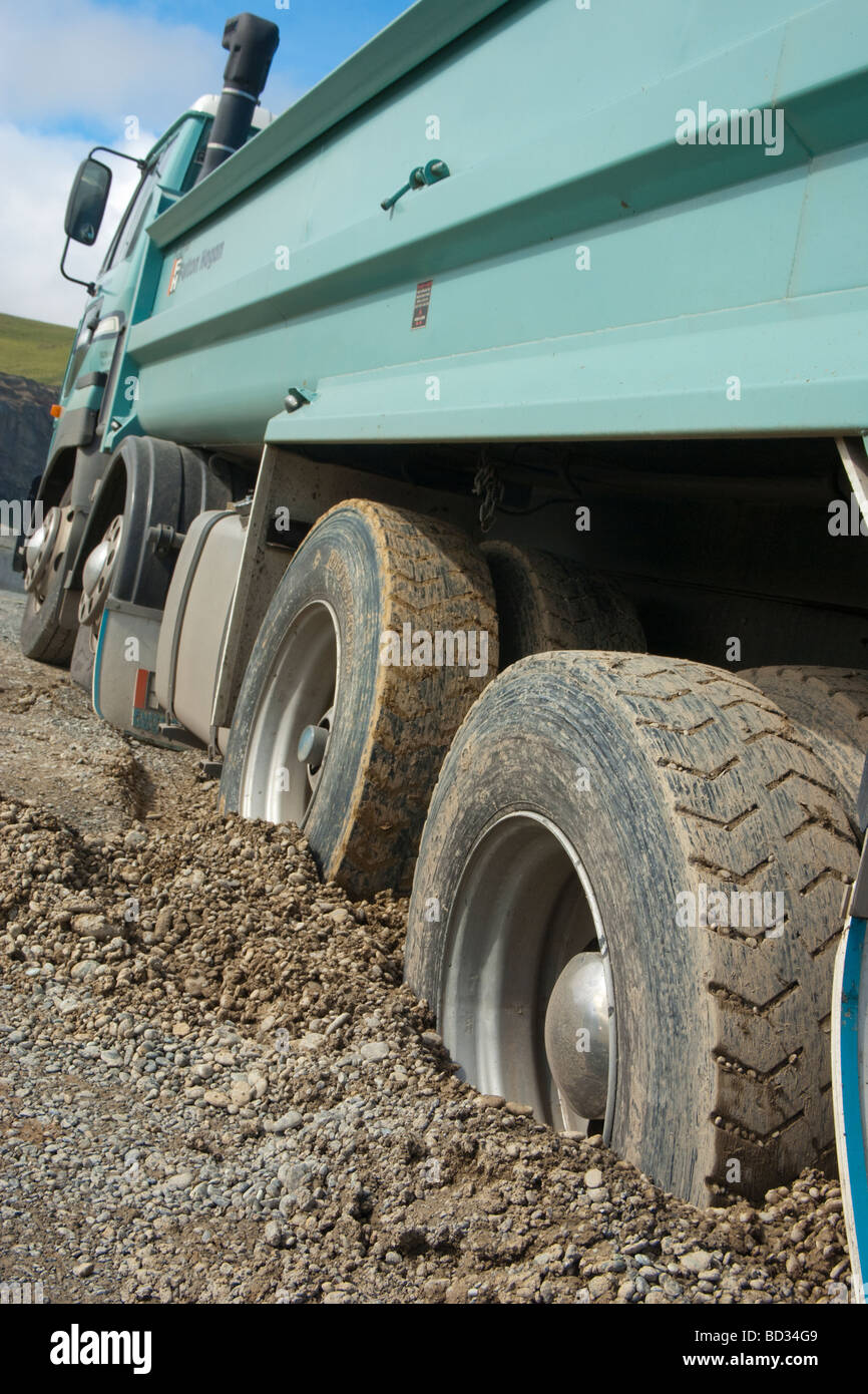 Heavy Goods Vehicle stuck up to its axles in shingle Stock Photo