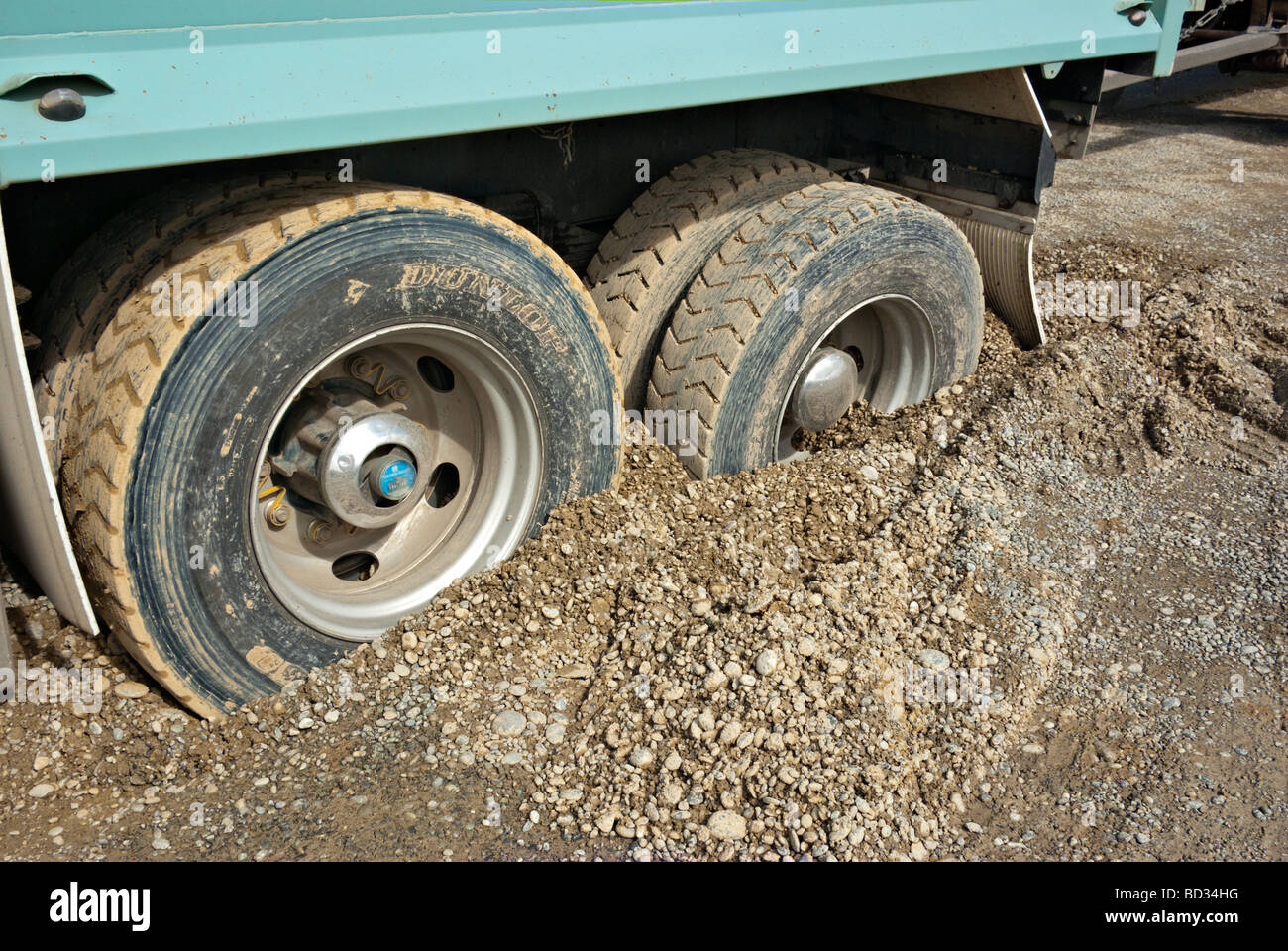 Heavy Goods Vehicle stuck up to its axles in shingle Stock Photo