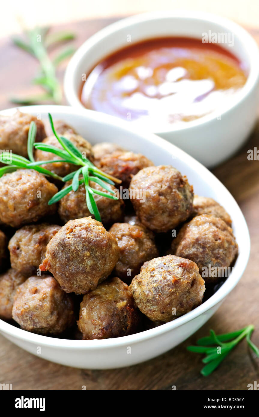 Fresh hot meatball appetizers served in white bowl with dipping sauce Stock Photo