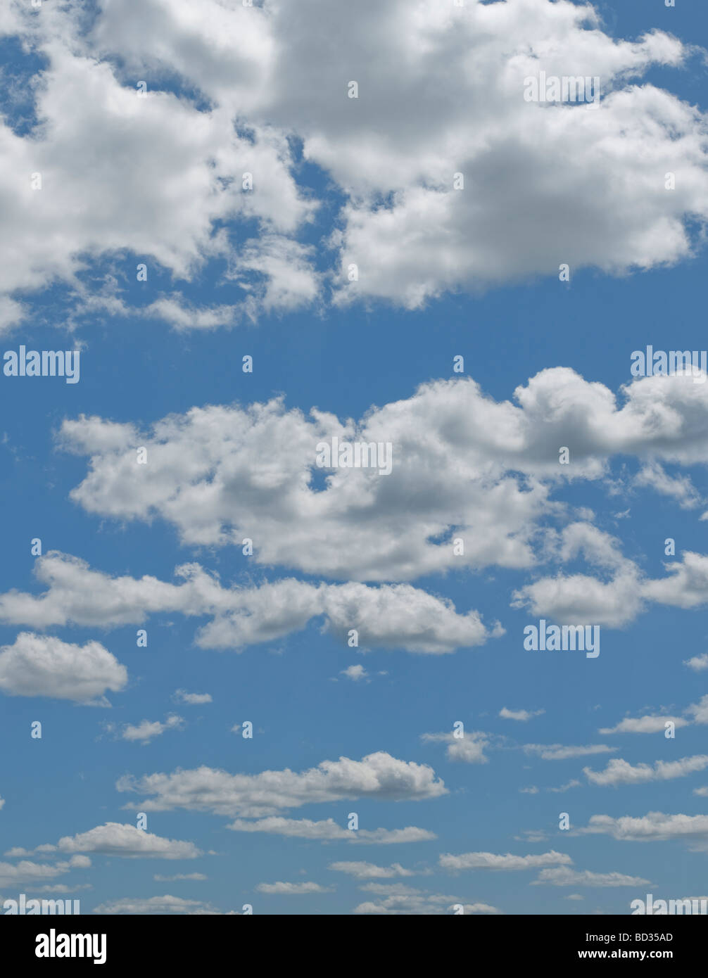 Blue sky puffy clouds Stock Photo
