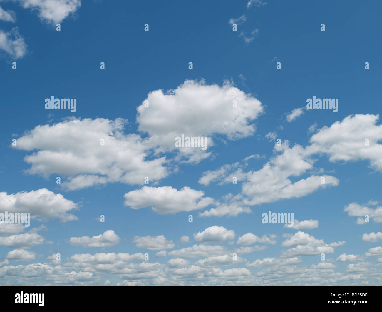 Blue sky puffy clouds Stock Photo