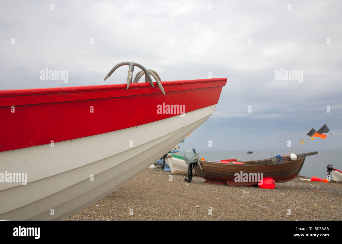 Bow of and fishing boats pulled up on the beach at Klitmøller on the north western coast of Jutland, Denmark on an overcast day Stock Photo