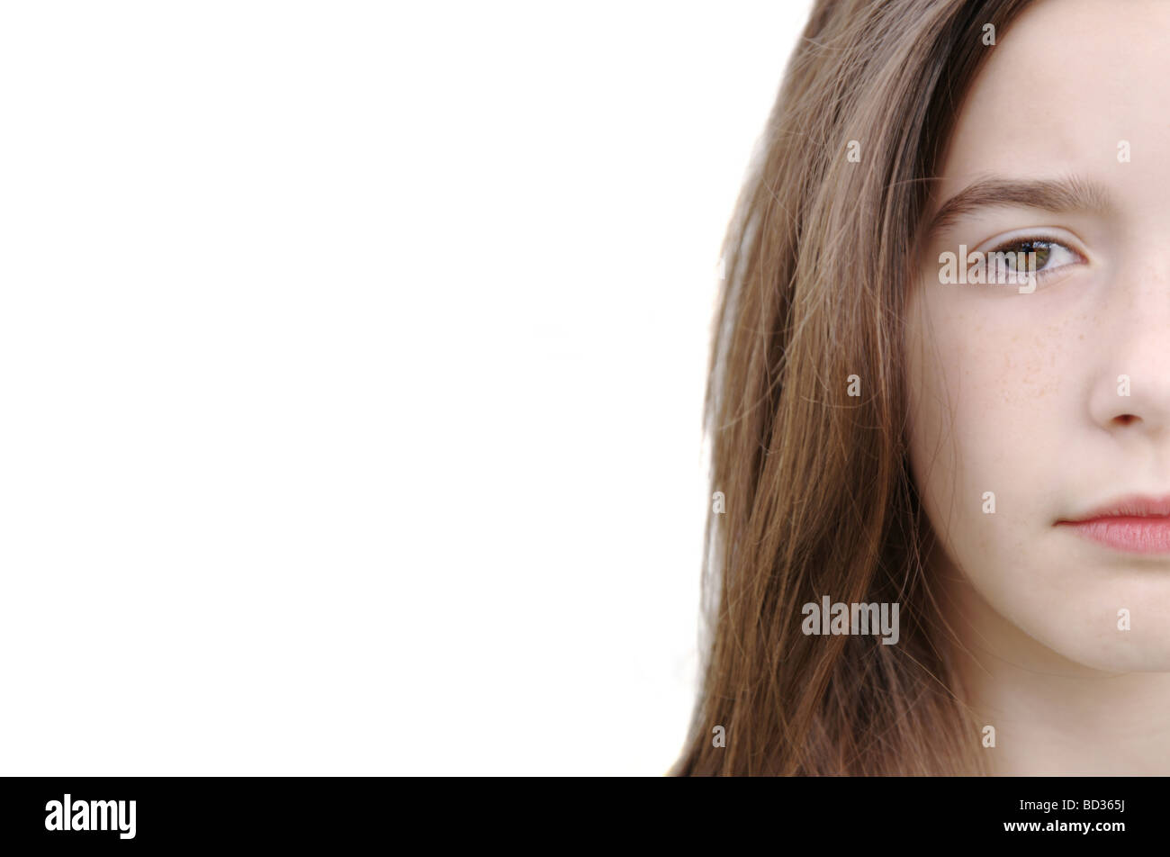 Half face portrait of a young girl over pure white background with plenty of space for text Stock Photo