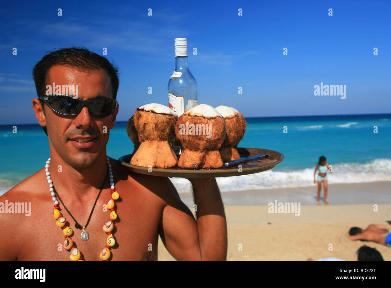 Barman with coconut rum cocktails on Playa Megano, Playas del Este, Havana, Cuba. Photo CUBA1230 Copyright Christopher P Baker Stock Photo