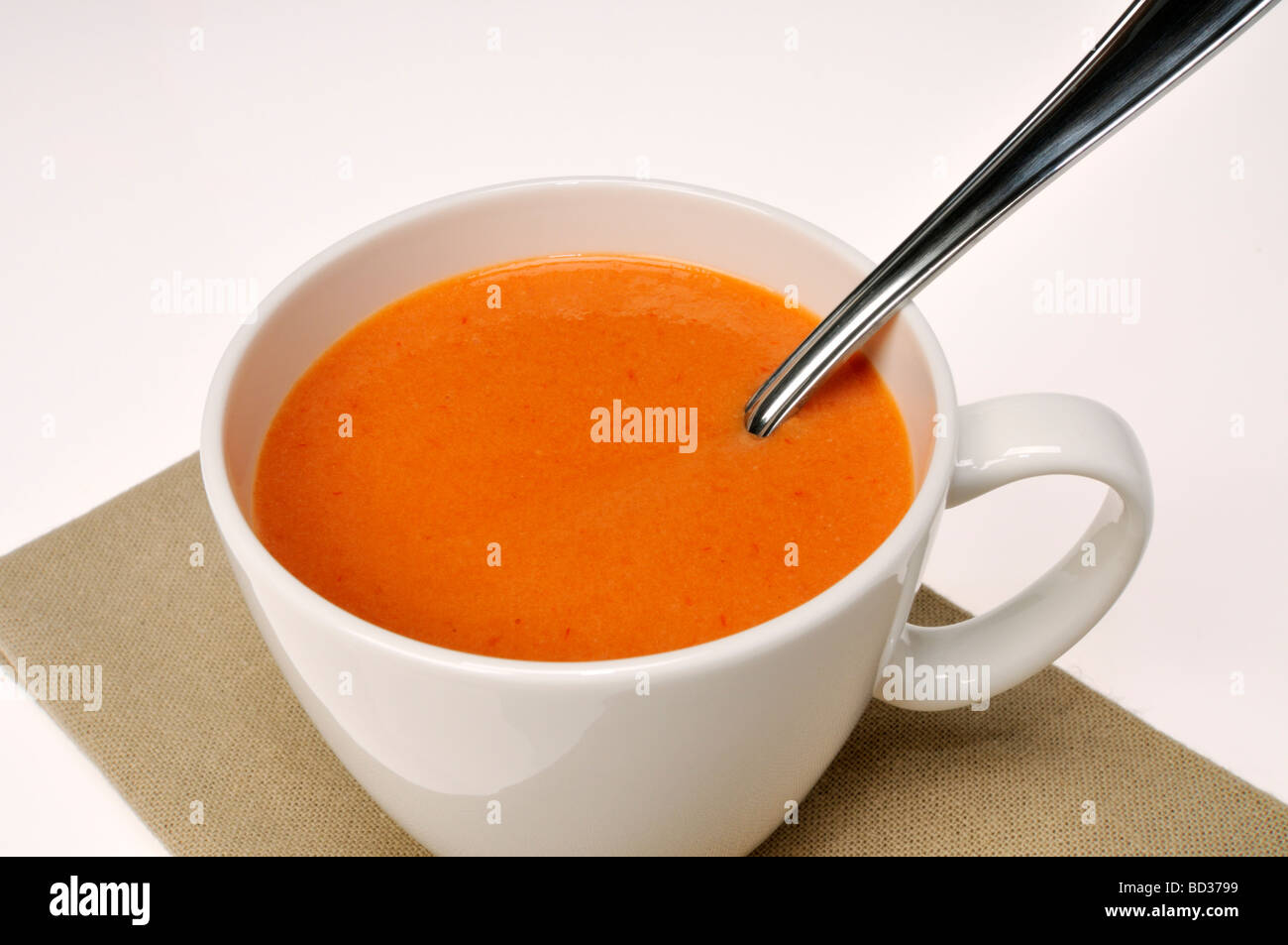 Cup of tomato soup with spoon Stock Photo