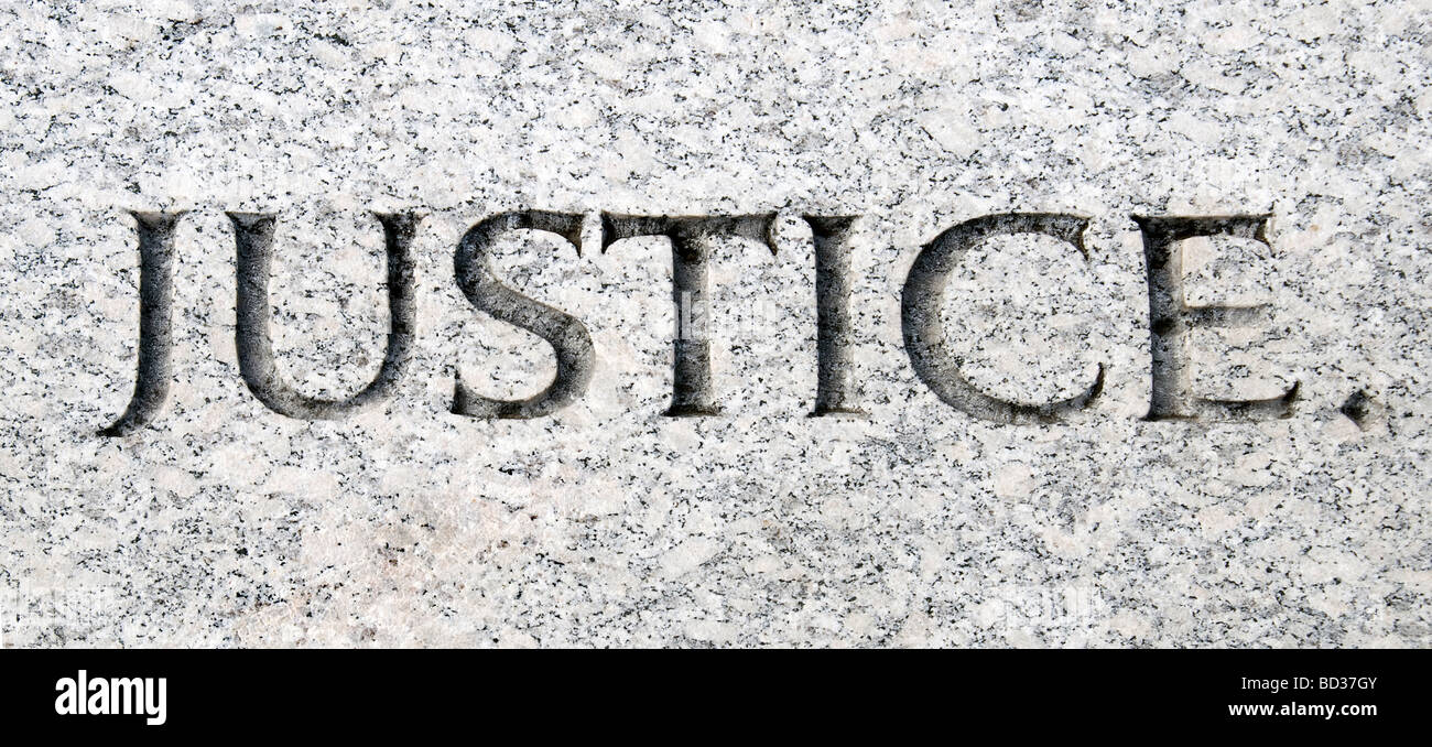 The word justice carved in stone Stock Photo Alamy