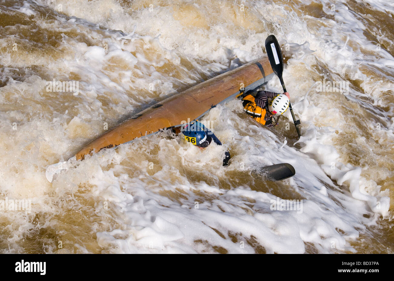 Capsized twoman kayak shooting Bells Rapids in the annual West