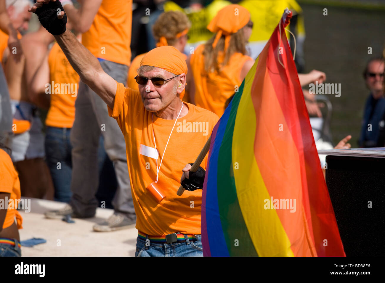 Gay senior with rainbow flag proudly participating in the 2009 Amsterdam Gay Pride Canal Parade. Stock Photo