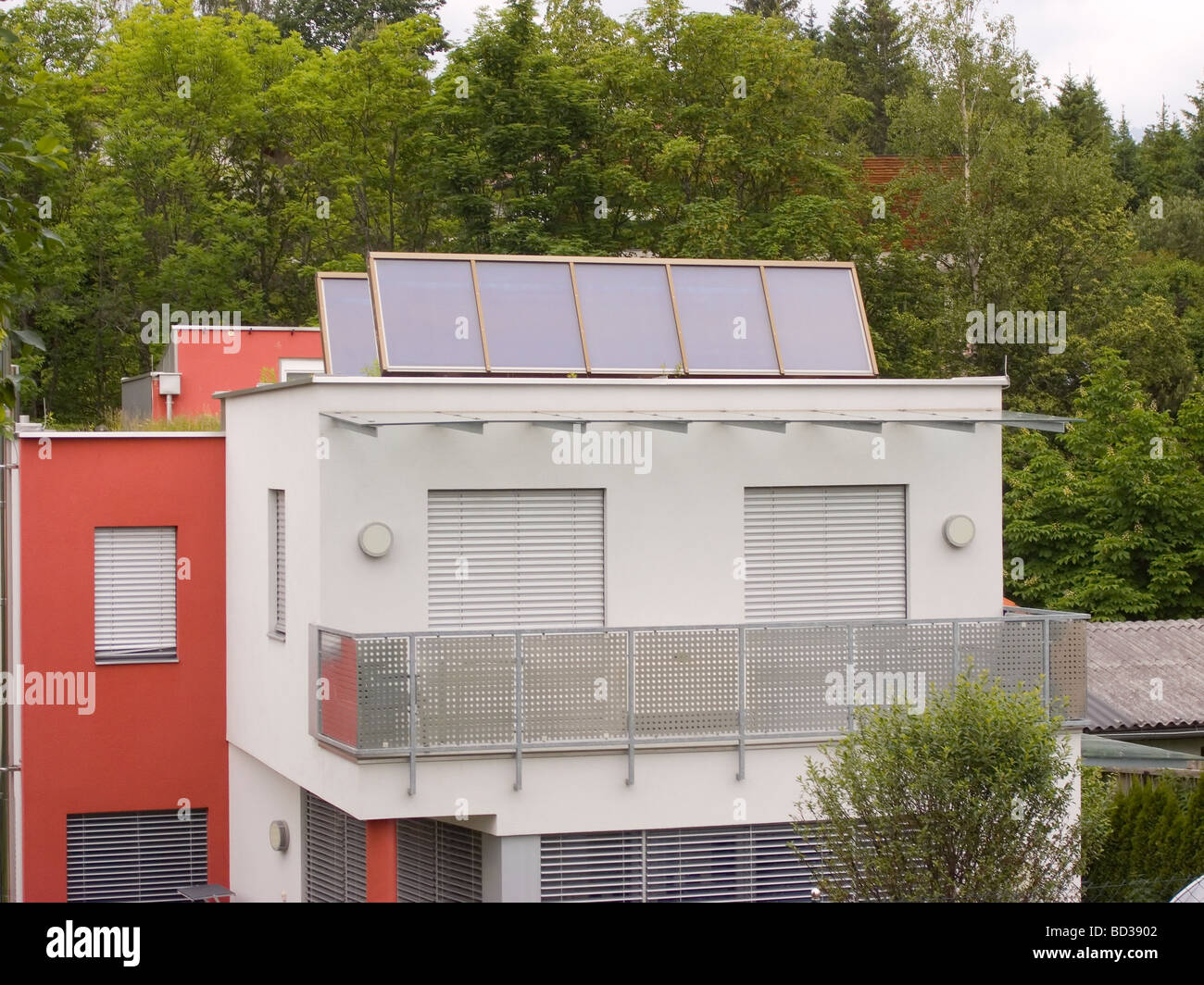 A modern house fitted with an array of solar panels for water heating ...