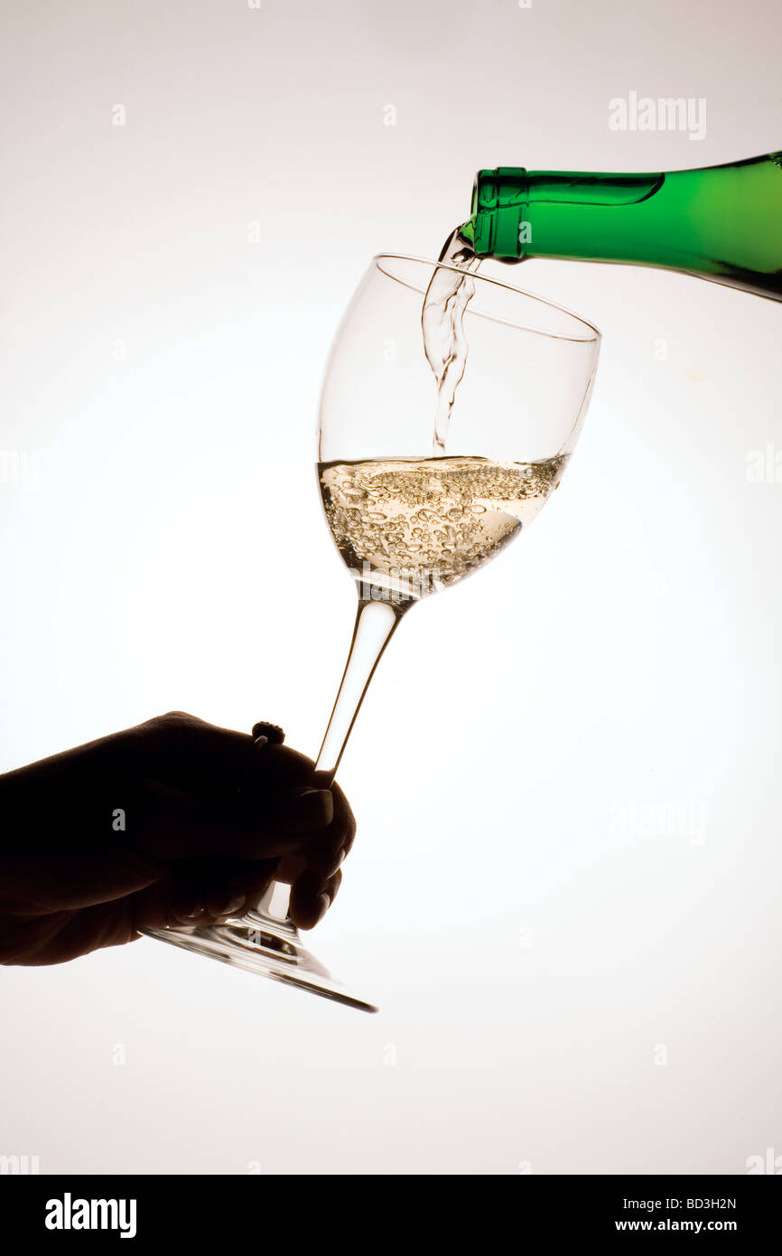 serving white wine in a glass Stock Photo