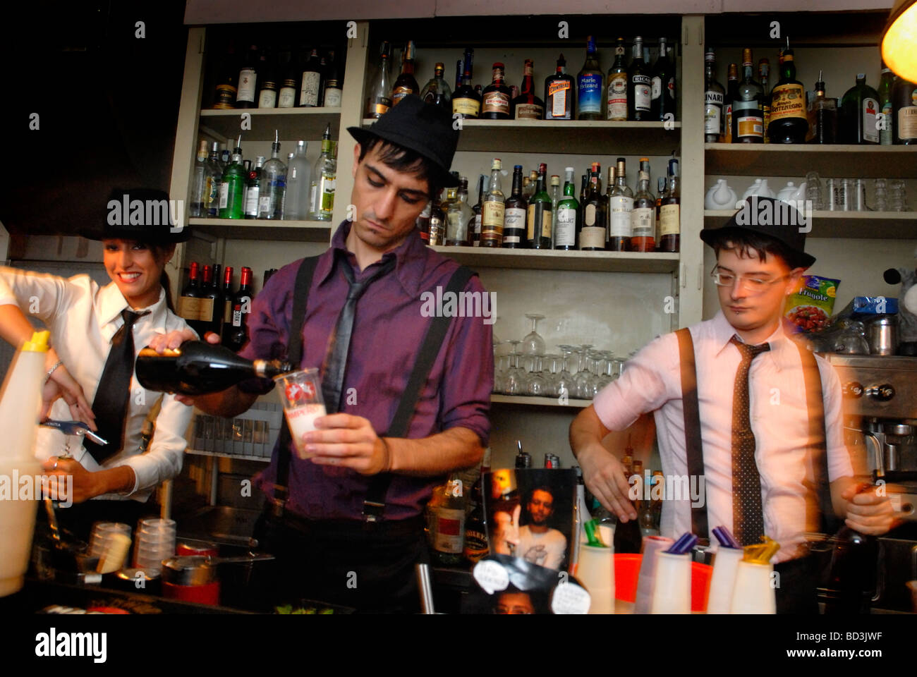 Bar staff making drinks at fashionable student bar, Societe Lutece, in