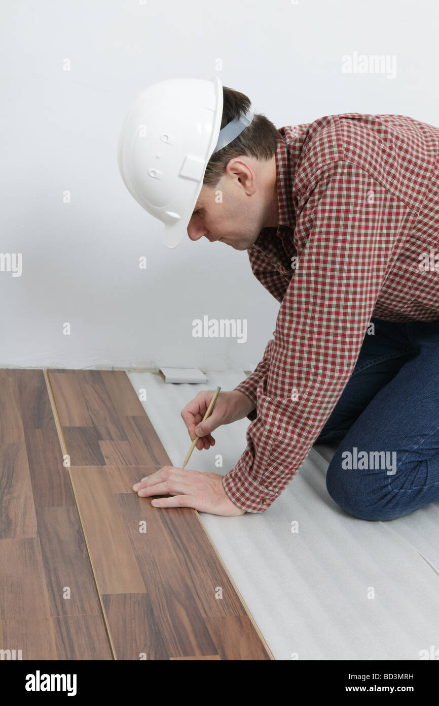 Man making the laminate flooring installation Stock Photo