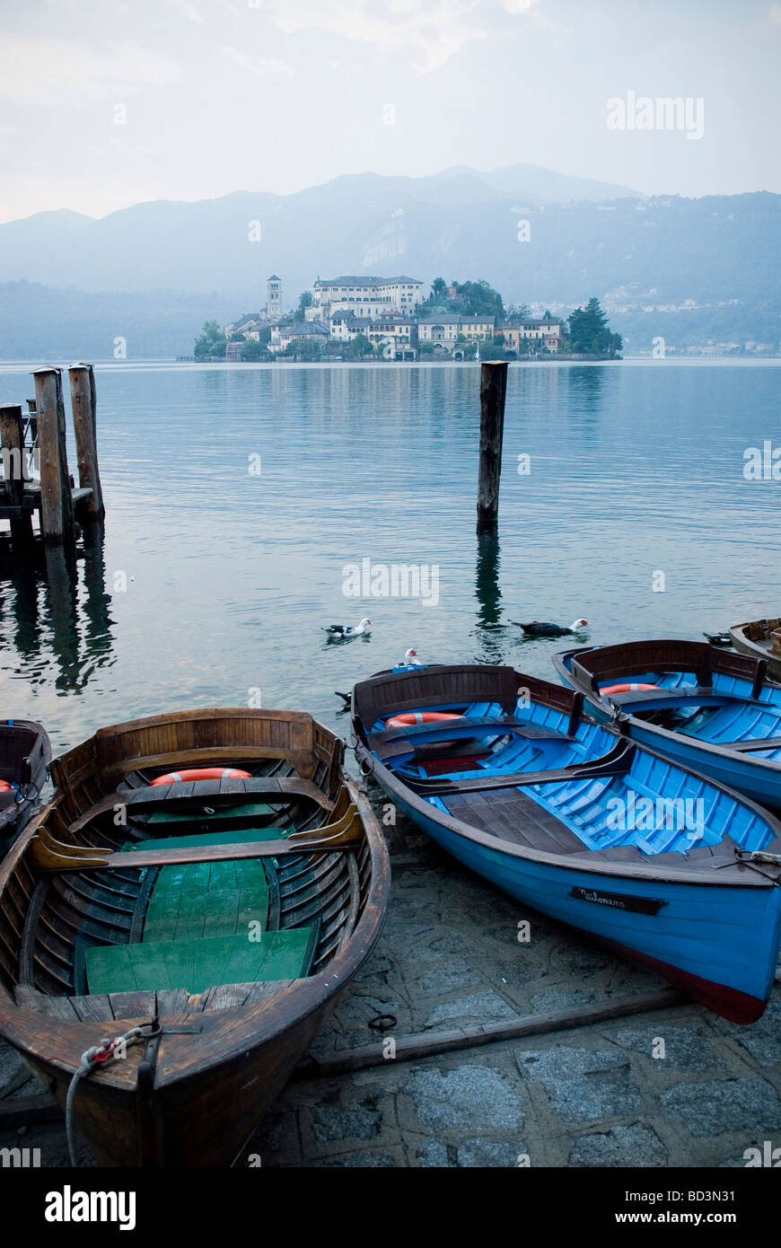 Old timber fishing boats on the lakes edge at Lago D Orta, Italy Stock Photo