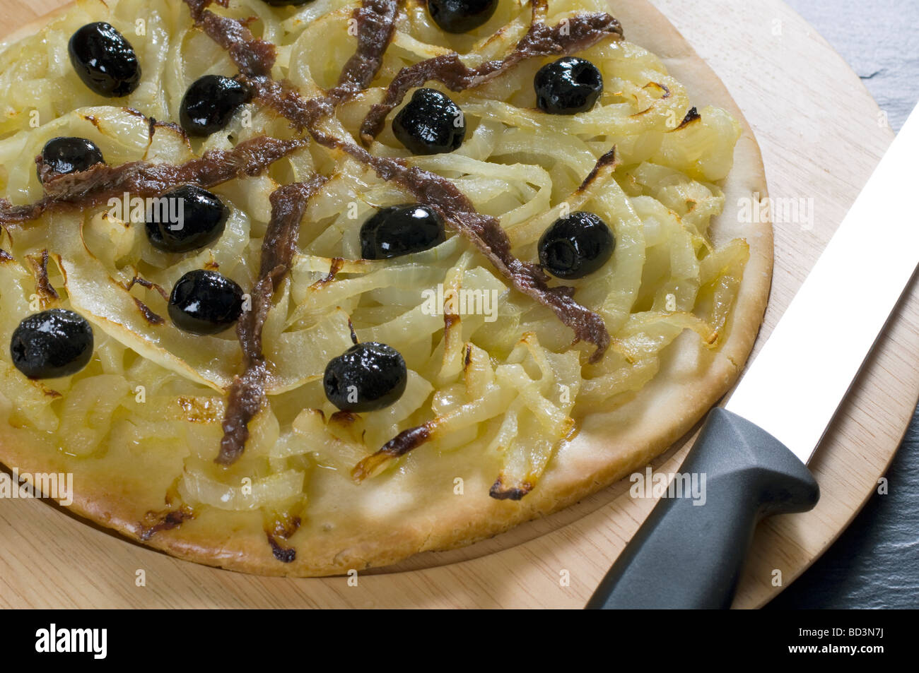 A pissaladiere pizza made of onions black olives and anchovies Stock