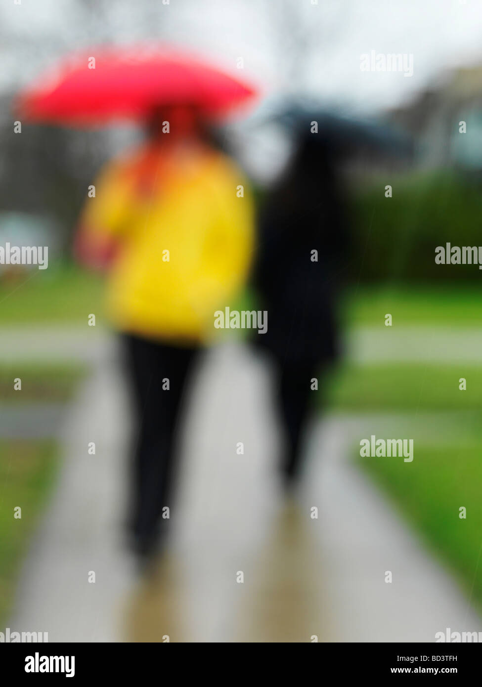 People with umbrellas on a sidewalk in the rain Stock Photo - Alamy