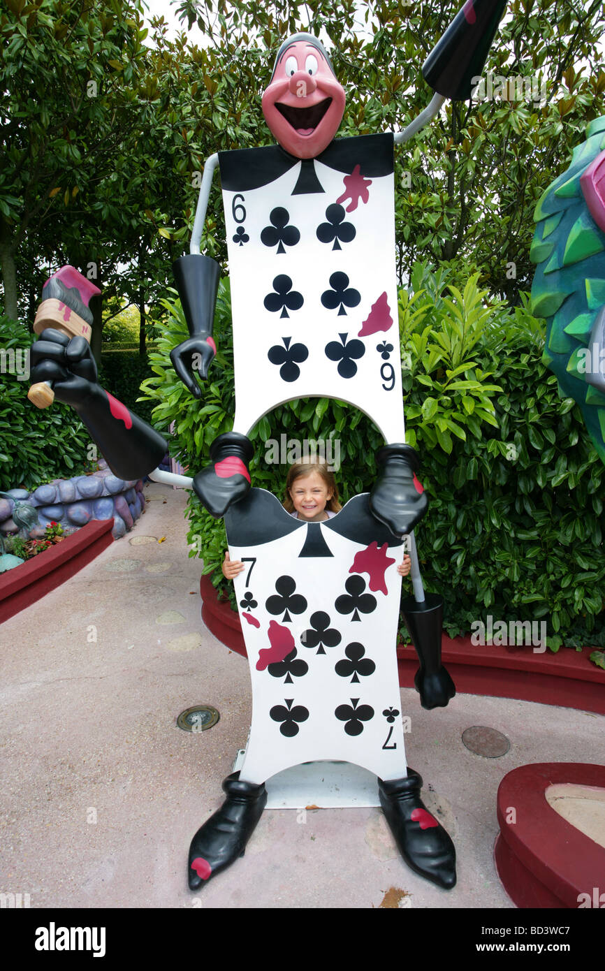 A young girl smiles in Alice's Curious Labyrinth, Disneyland Paris, France Stock Photo
