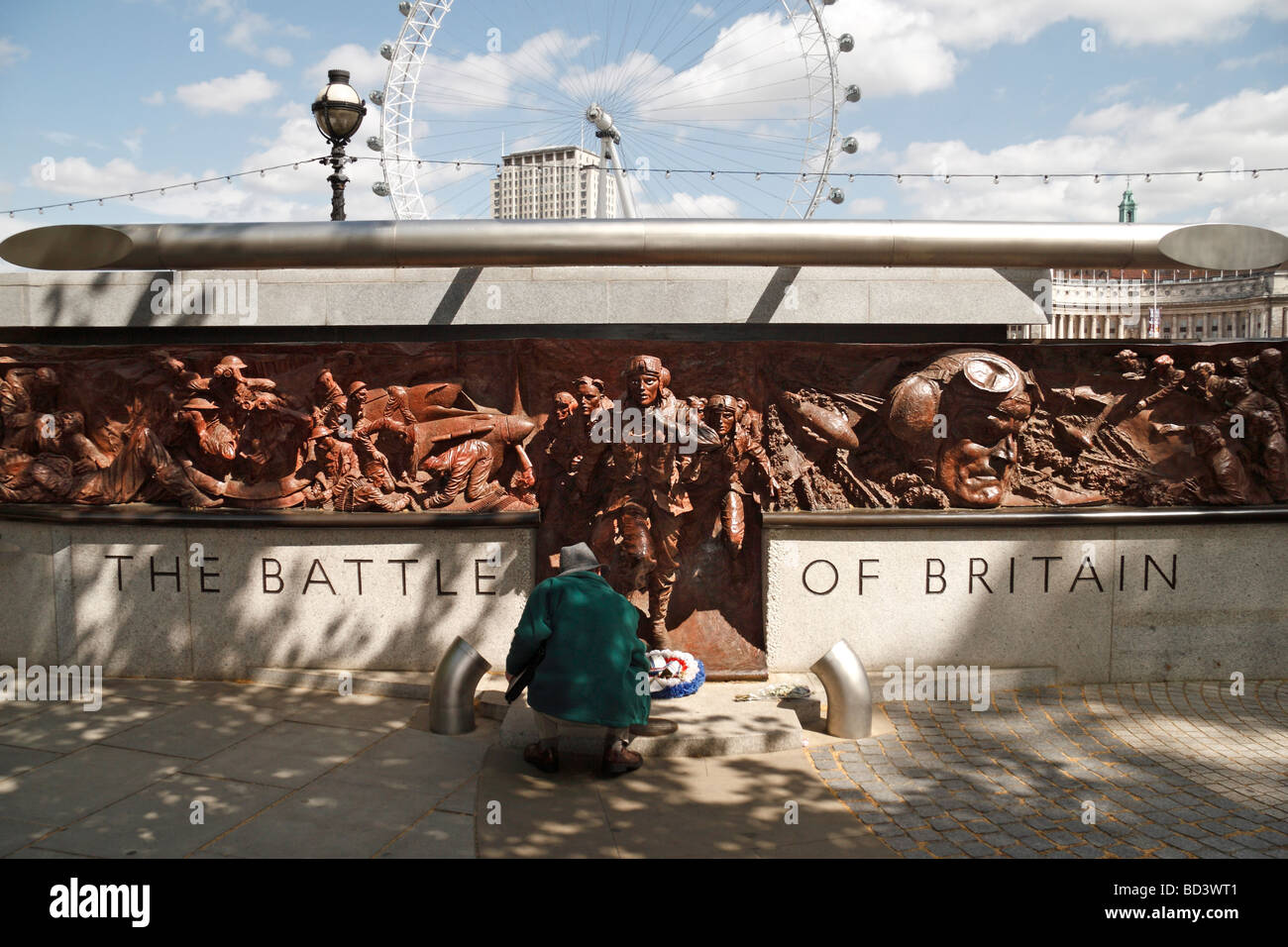 A visitor in front of the Battle of Britian Memorial, on the banks of the River Thames, London, UK. Stock Photo