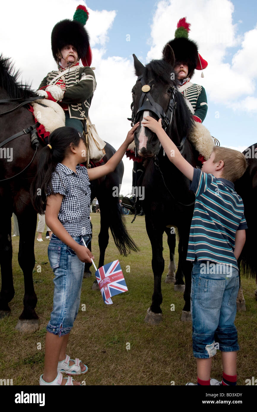 Children greet mounted Civil War re-enactors at the Colchester Military Festival in Colchester, Essex, England Stock Photo