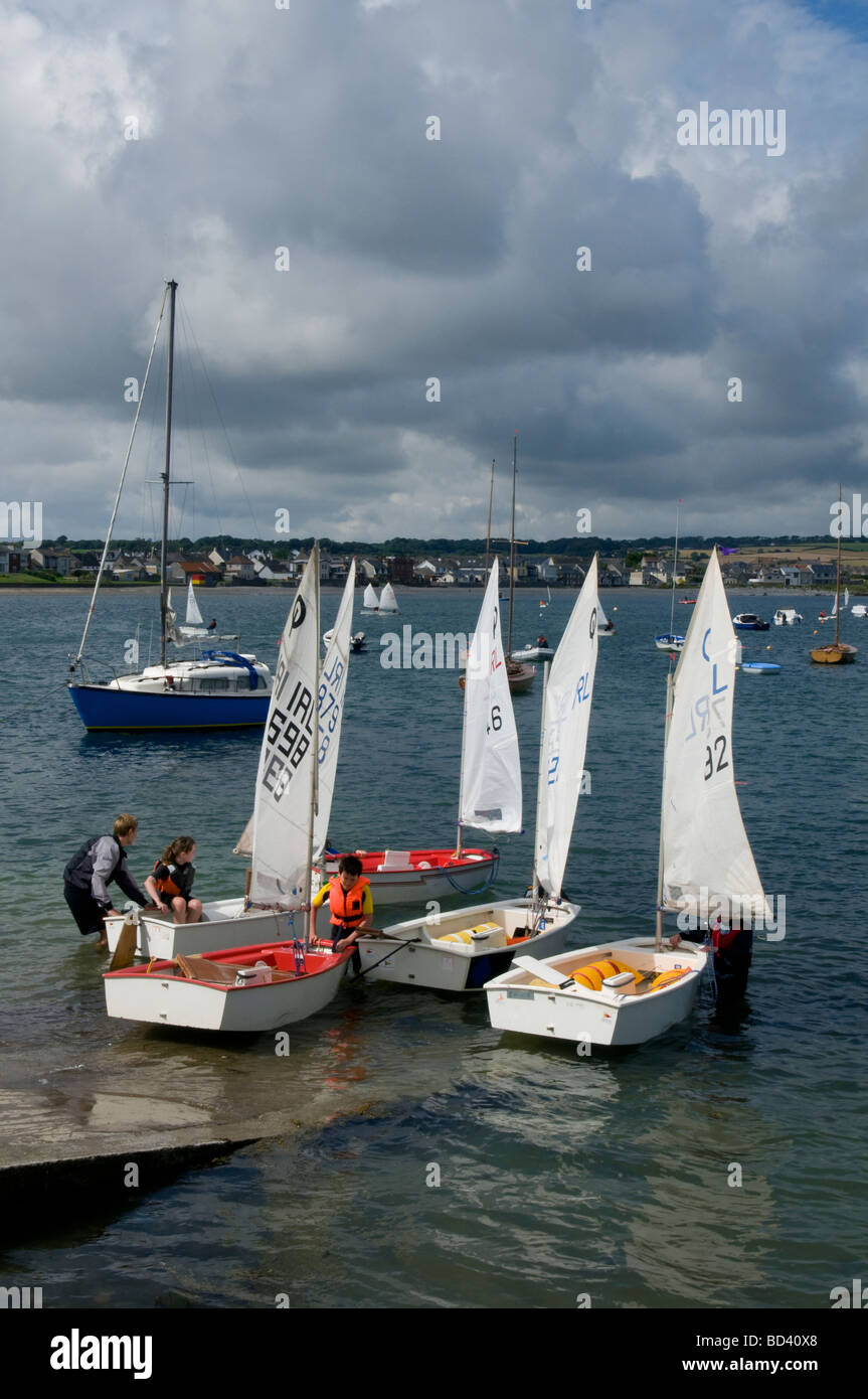 Children launching their Optimist sailing dinghies at the slipway in Skerries harbour north County Dublin Ireland Stock Photo