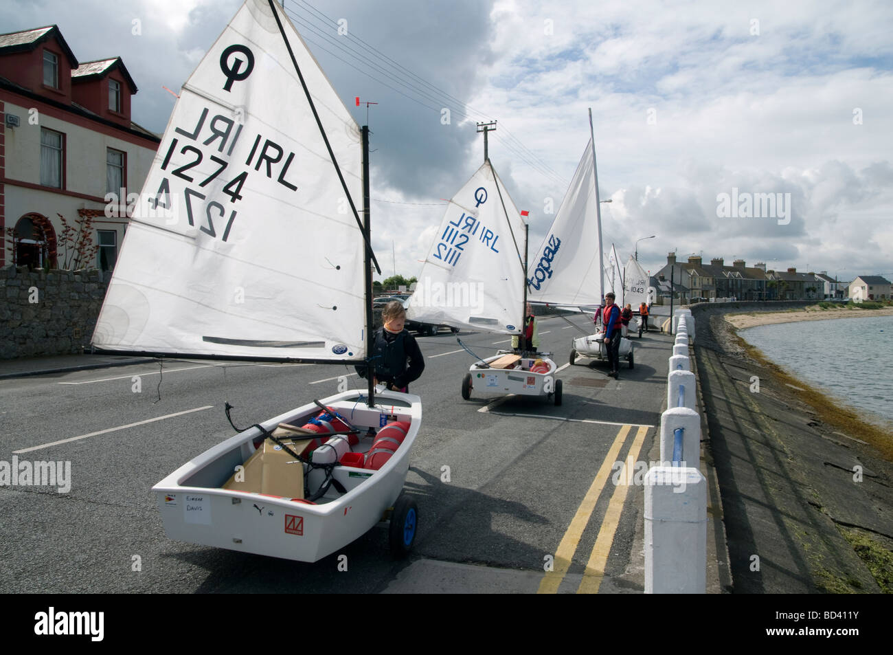 Children launching their Optimist sailing dinghies at the slipway in Skerries harbour north County Dublin Ireland Stock Photo