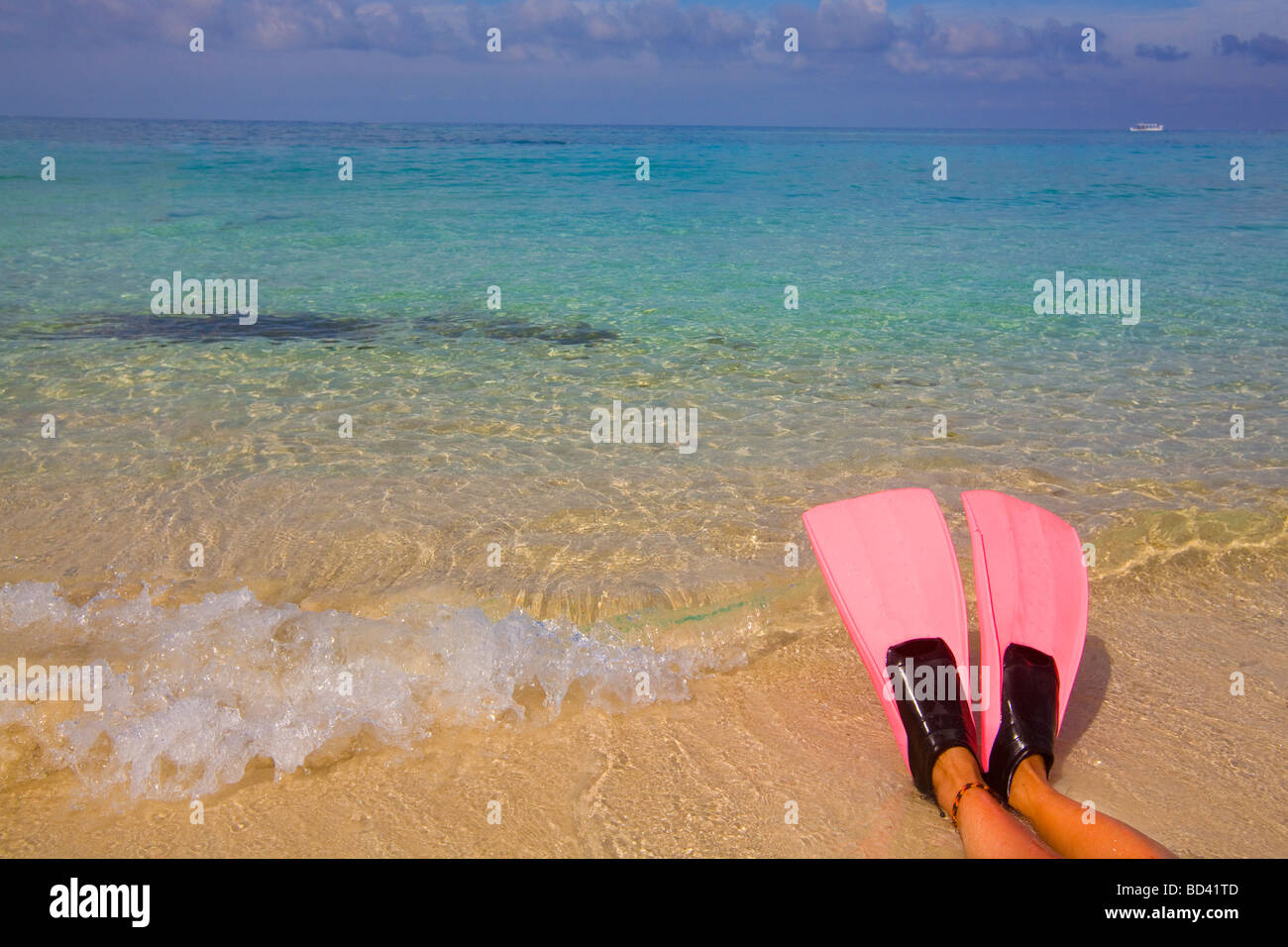 Pink swim fins and the Caribbean, Roatan Island, Honduras Stock Photo