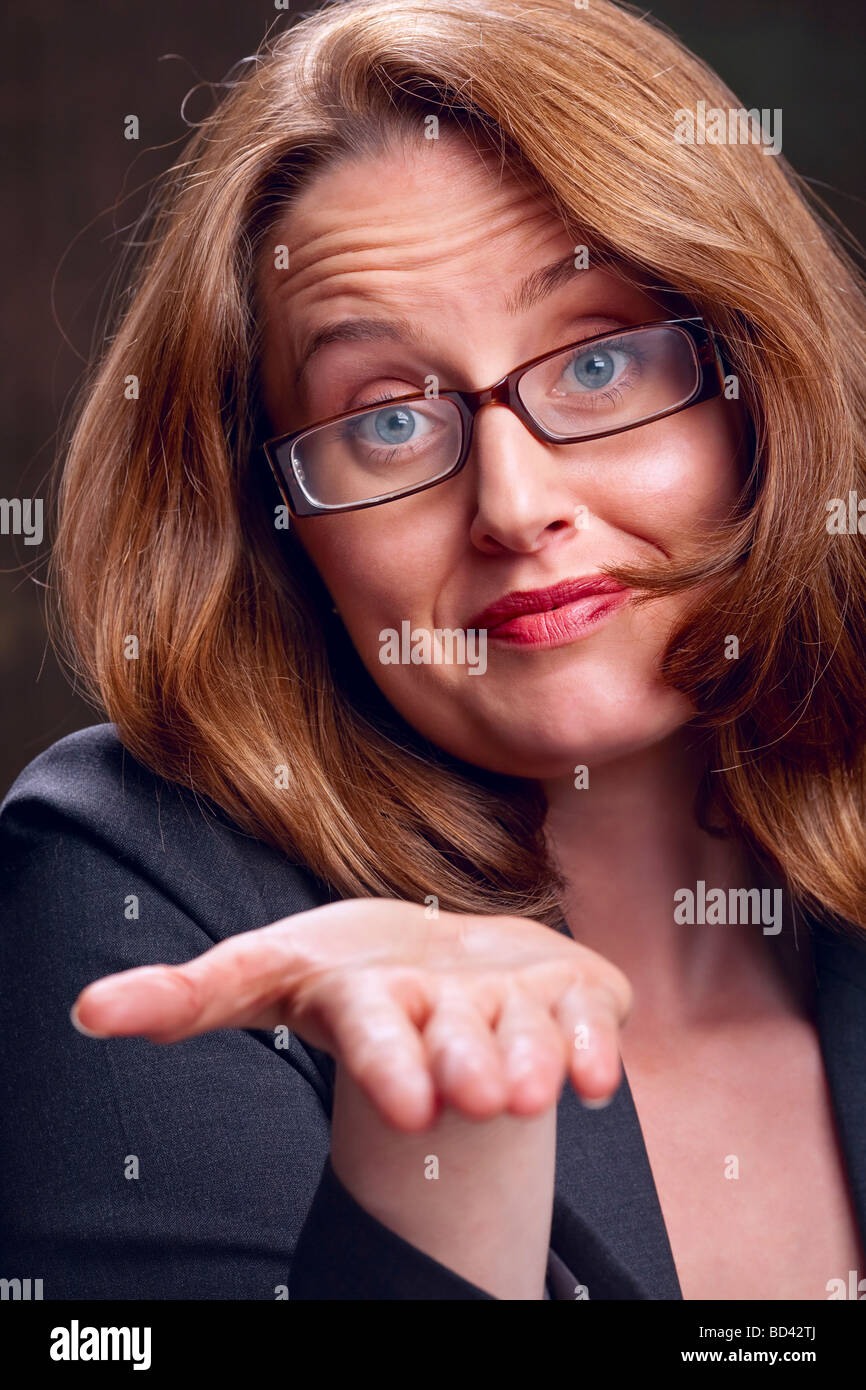 Portrait of redhaired businesswoman offering her open palm Stock Photo
