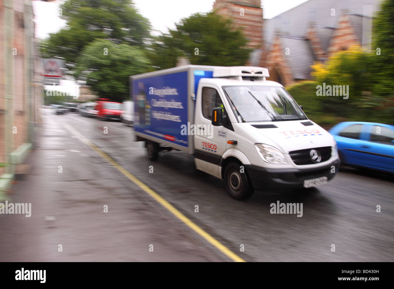Tesco online home delivery shopping van driving to deliver food on a wet day in Somerset Stock Photo