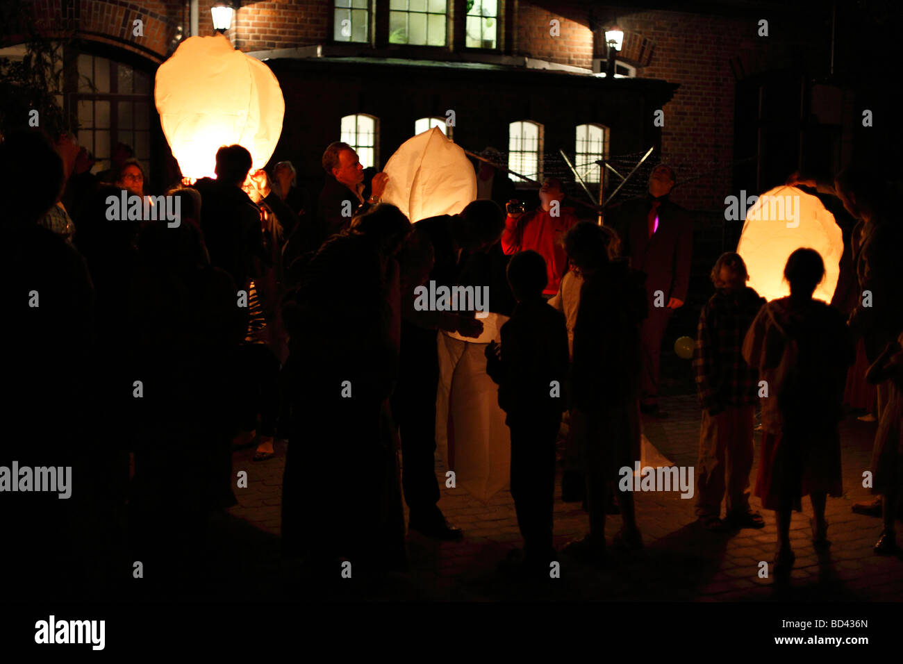 launching sky lanterns; floating lantern Stock Photo