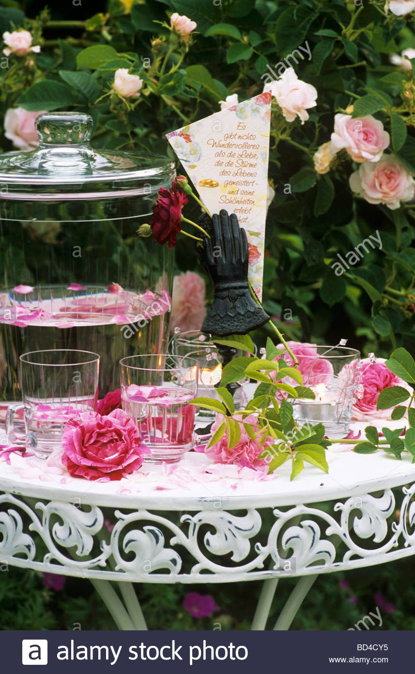 romantic table with roses rose punch and love poem stock photo