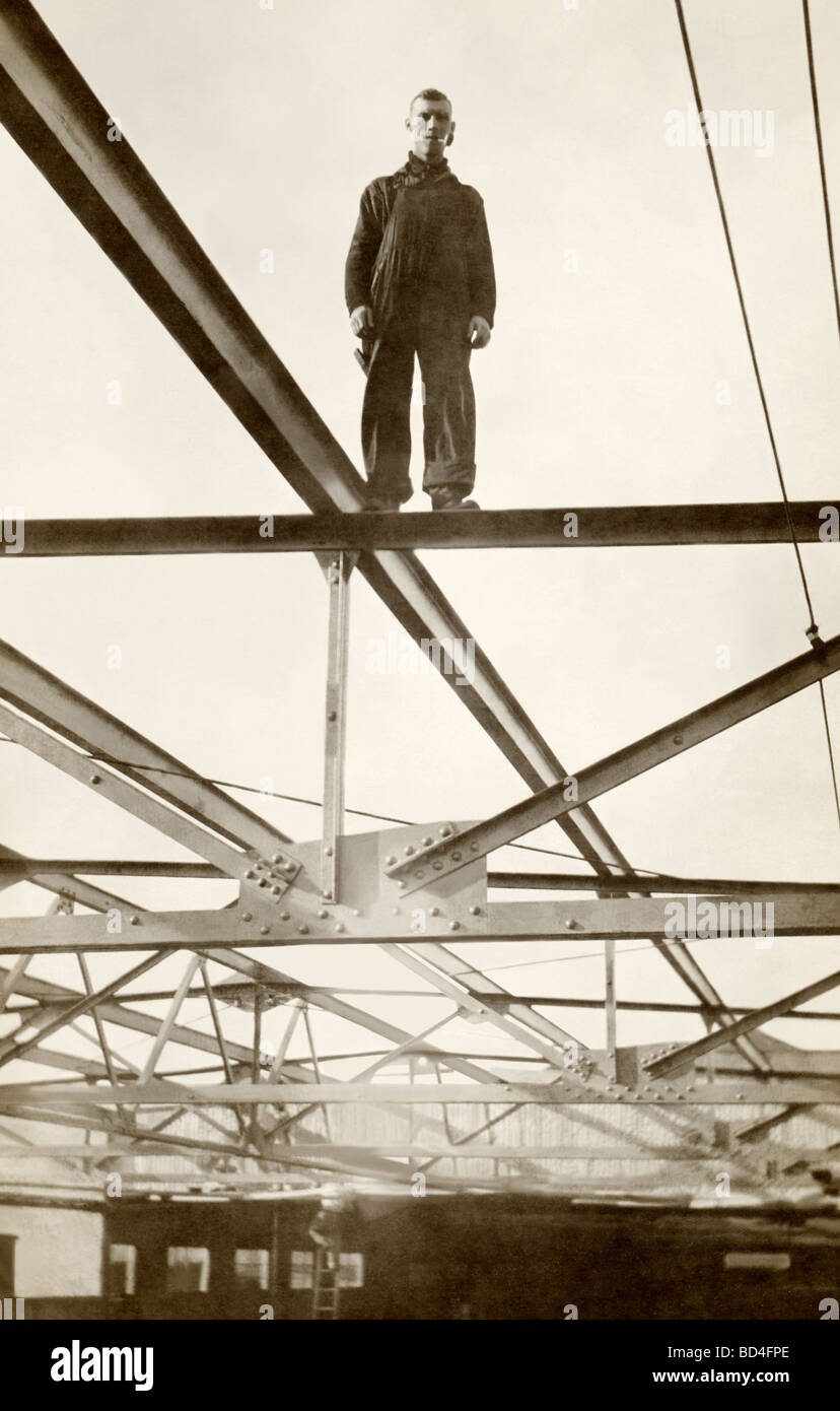 Man Standing at the Top of A Steel Frame Stock Photo