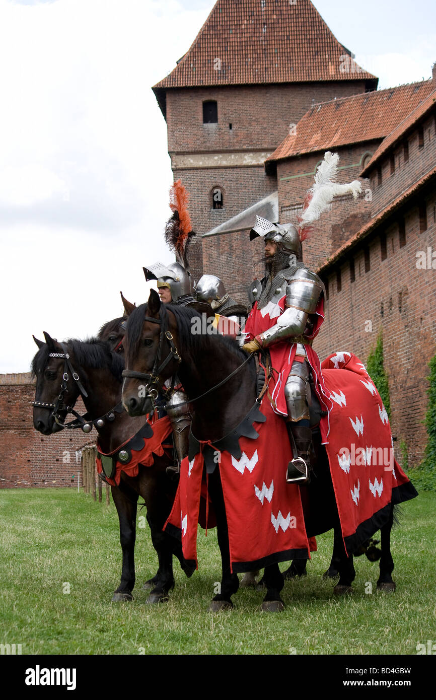 Medieval cavalry knights on military horses presenting themselves to the audience. Taken in Malbork, Poland, 2009. Stock Photo