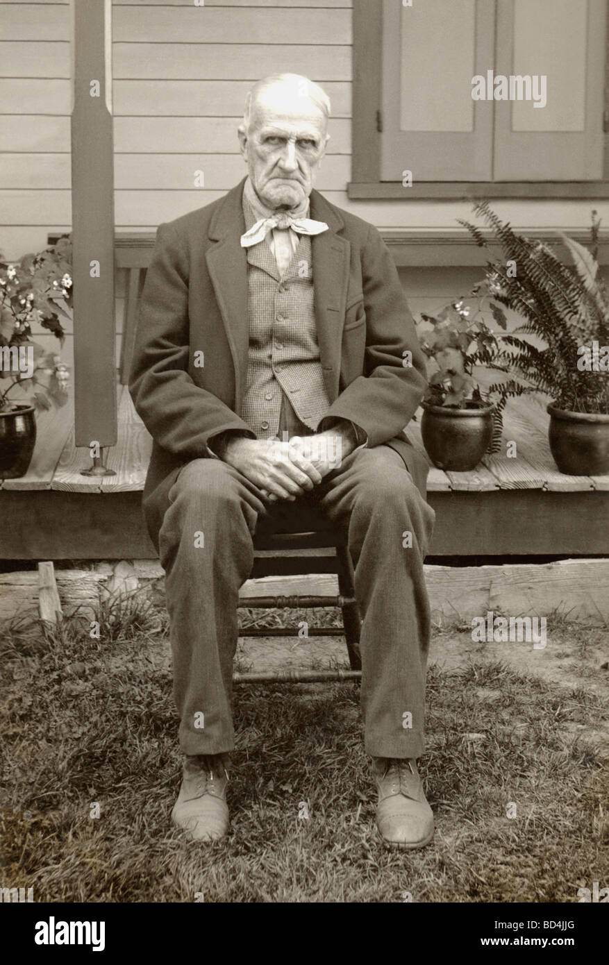 Sad, Depressed Old Man Sitting Outside Stock Photo