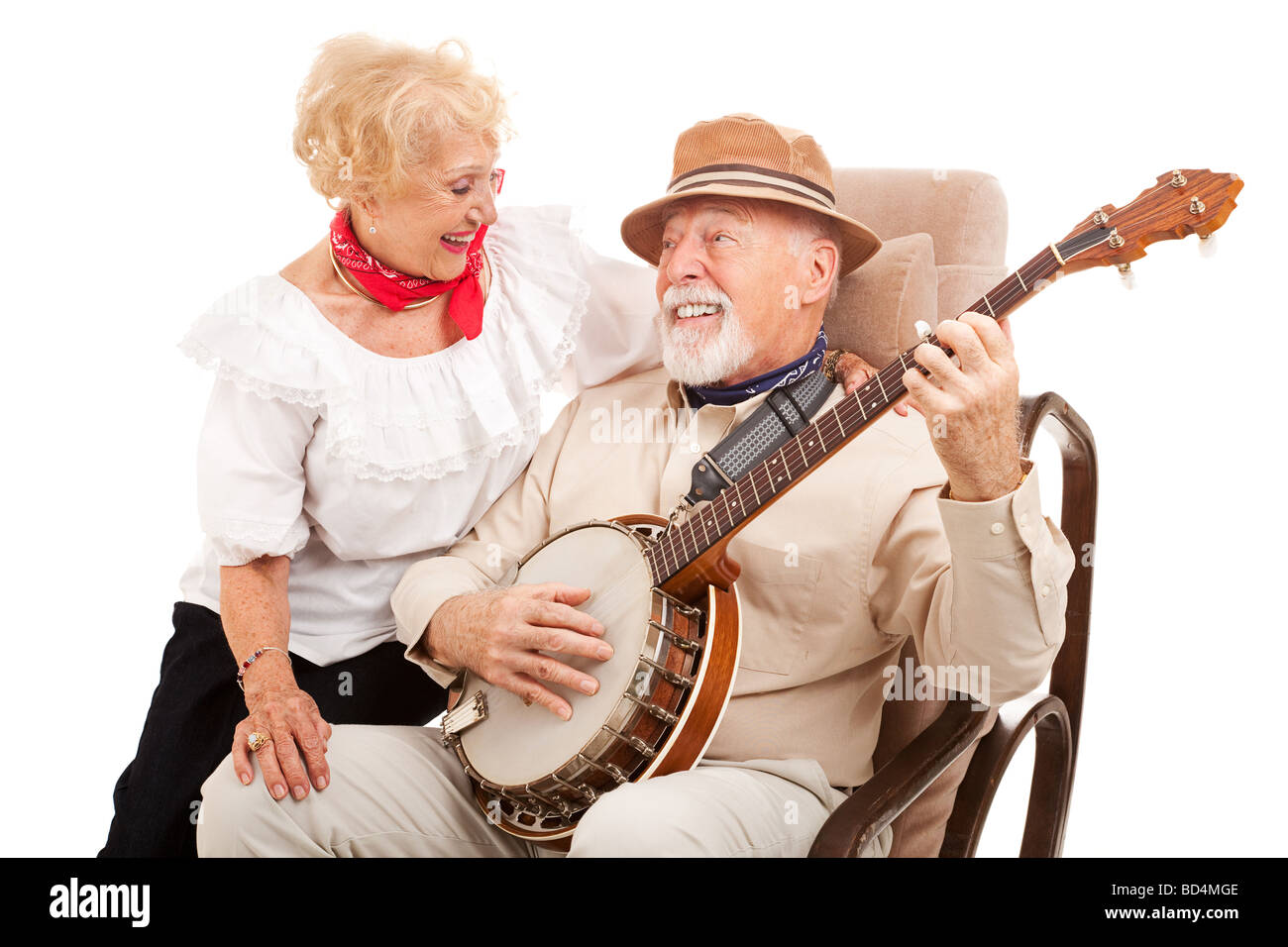 Senior man courts his lady love by playing banjo for her Isolated on white Stock Photo