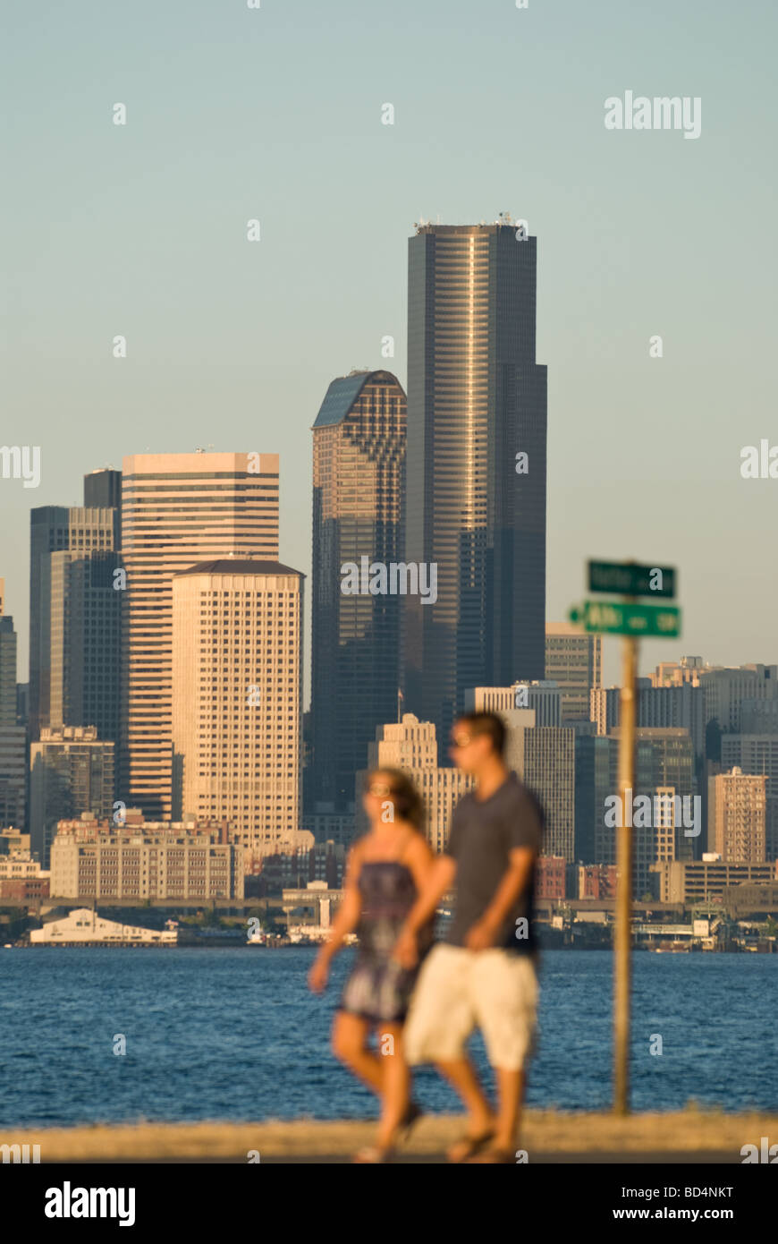 A couple walk along Alki Beach Park in Seattle, WA. Stock Photo