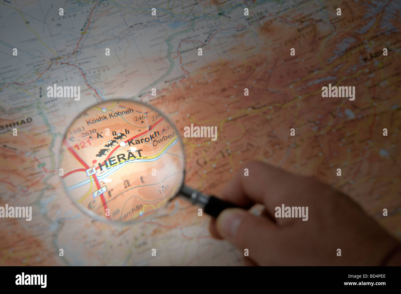 indicate with a finger the city of Herat on a map Stock Photo