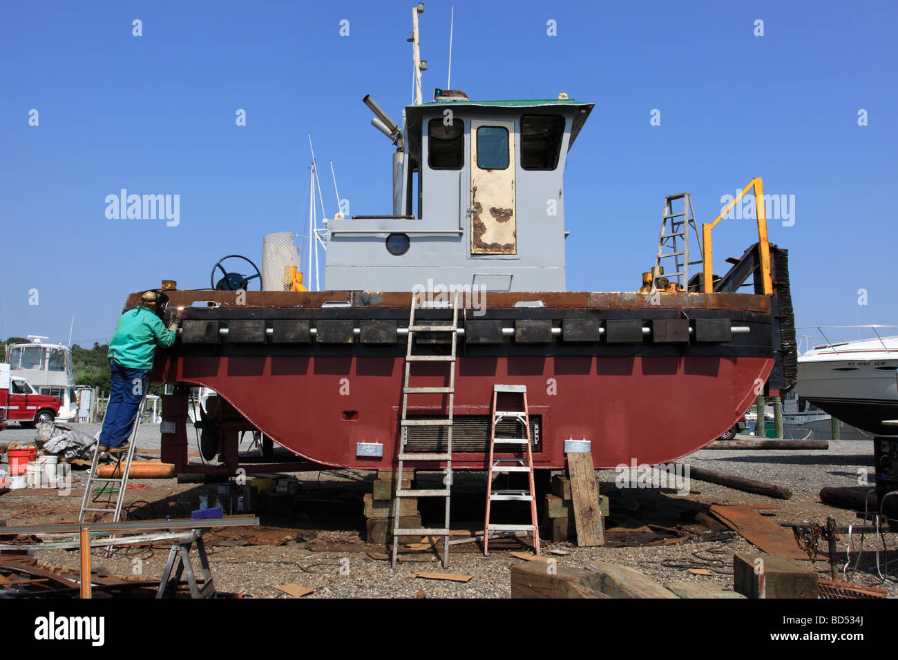 Worker welding on boat Long Island NY Stock Photo Alamy