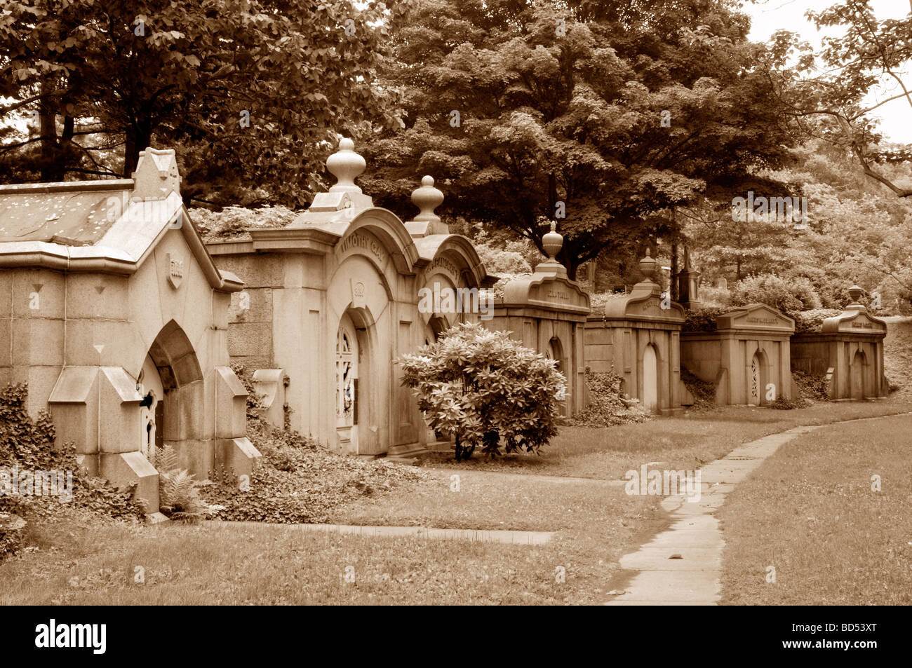 Group of old granite stone mausoleums in cemetery Stock Photo