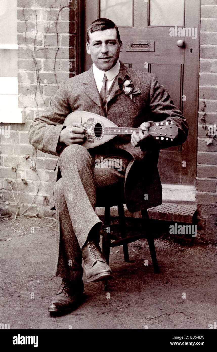 Well Dressed Man Playing Lute Outdoors Stock Photo