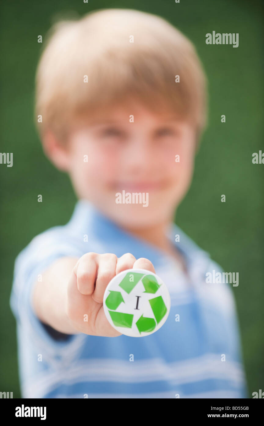 Young boy holding recycling button Stock Photo