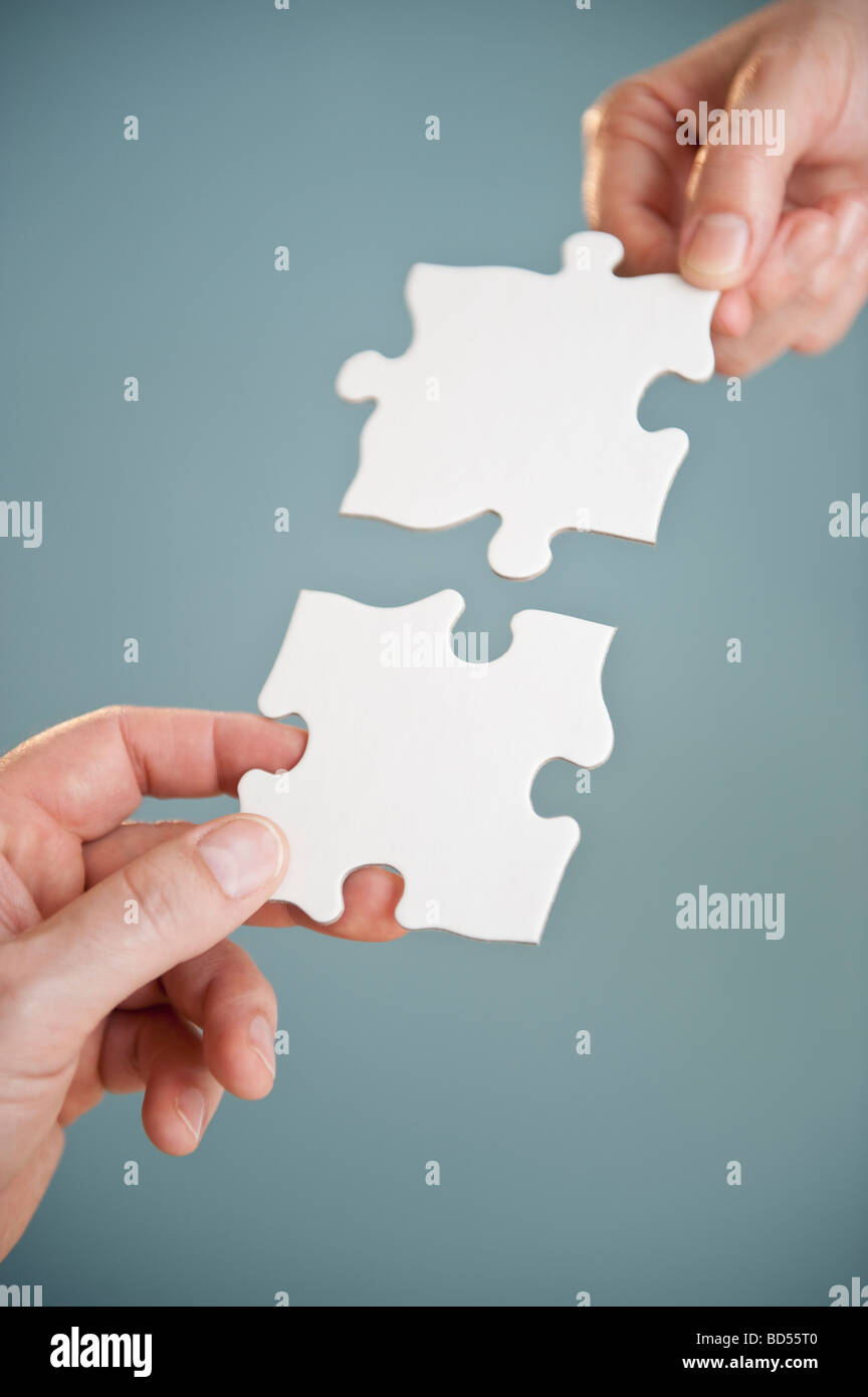 Hands holding puzzle pieces Stock Photo