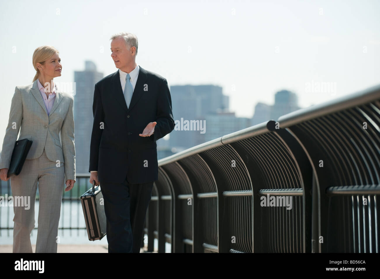 Two business people walking outdoors Stock Photo - Alamy