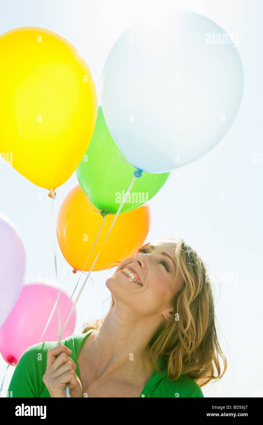 A woman holding balloons Stock Photo