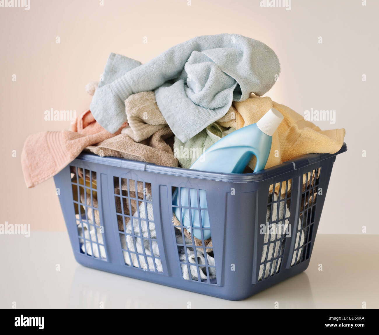 A laundry basket full of towels Stock Photo - Alamy