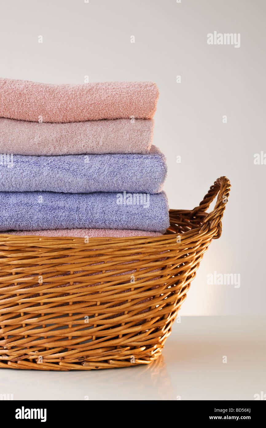 A laundry basket full of towels Stock Photo Alamy